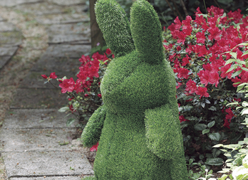 Garden plush in artificial turf, decorative and ingenious. Rabbit figure