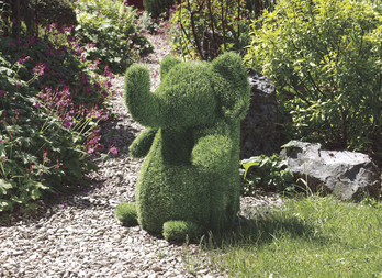 Garden plush in artificial turf, decorative and ingenious. Sitting elephant figurine