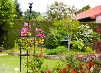 A curved metal structure, topped by a bird