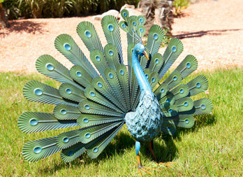 Stylised peacock fanning its feathers. In coloured metal